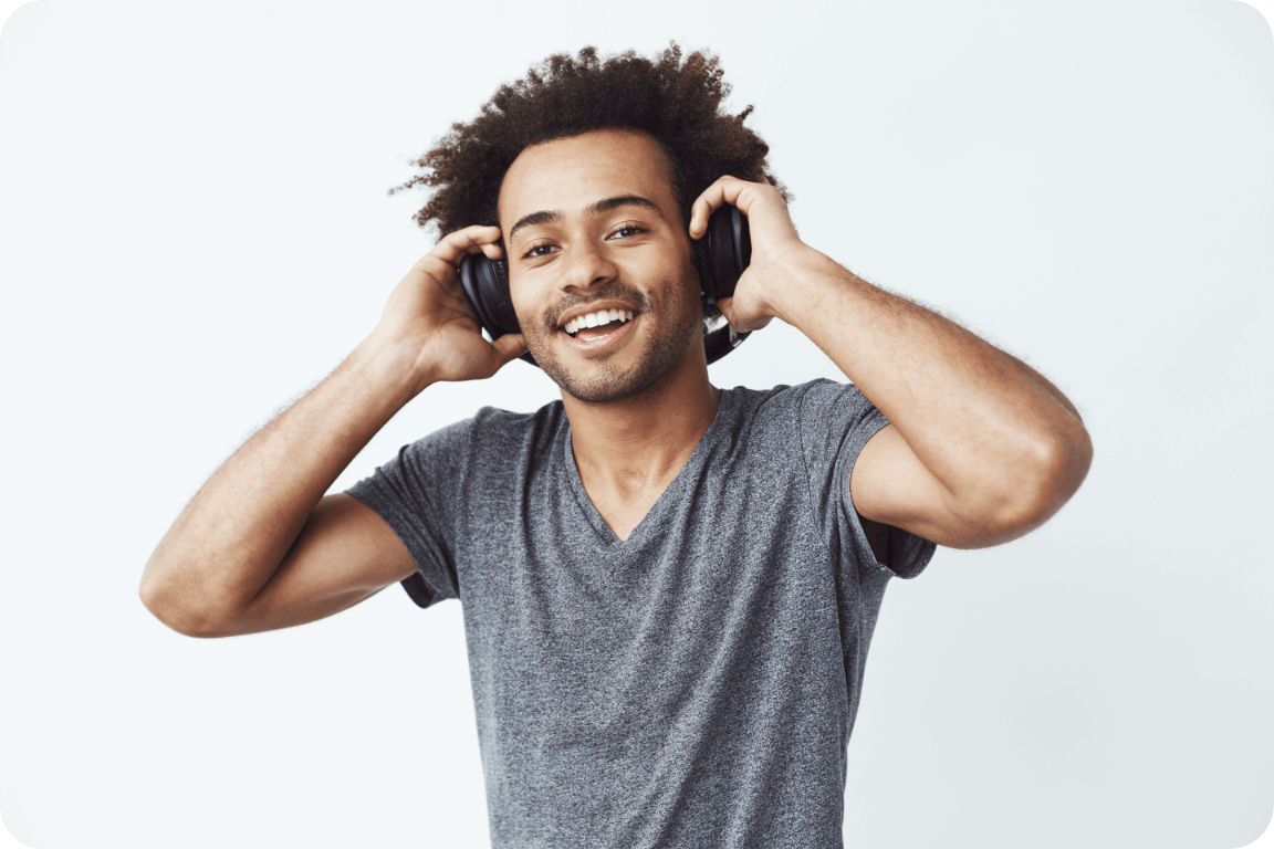 A young man grooving to music with headphones.