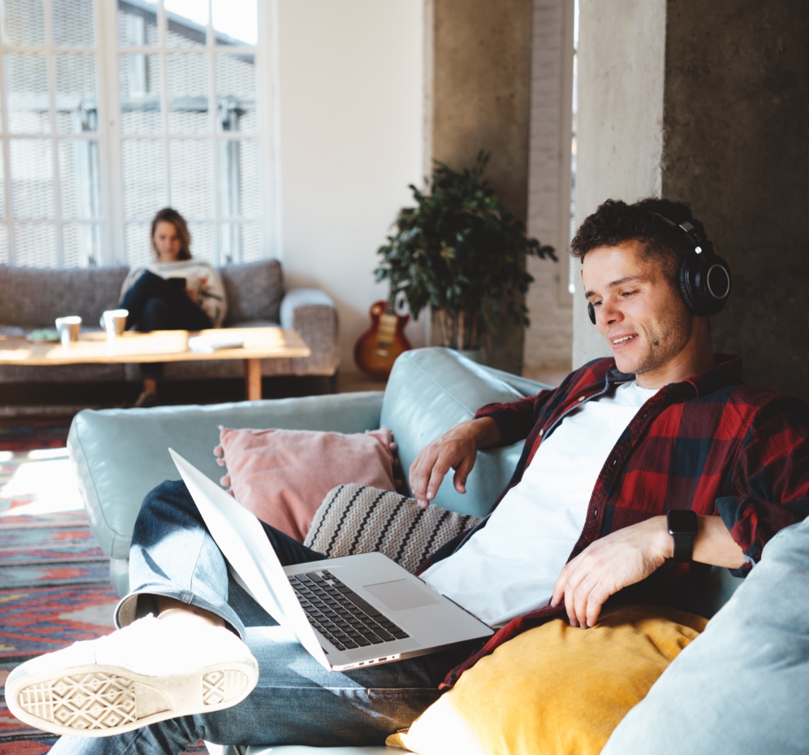 A young man reading the news while he listens to music.