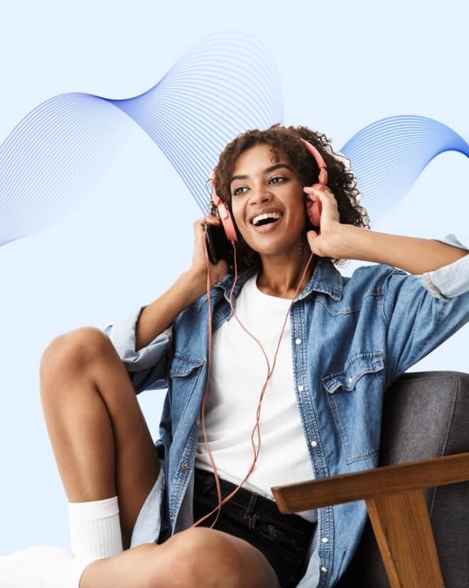 A young woman grooving to some music in her room.