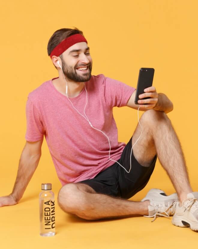 A young man checking out his tunes that match his current heart beat.