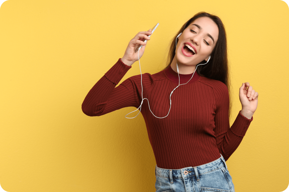 A happy young woman grooving to music