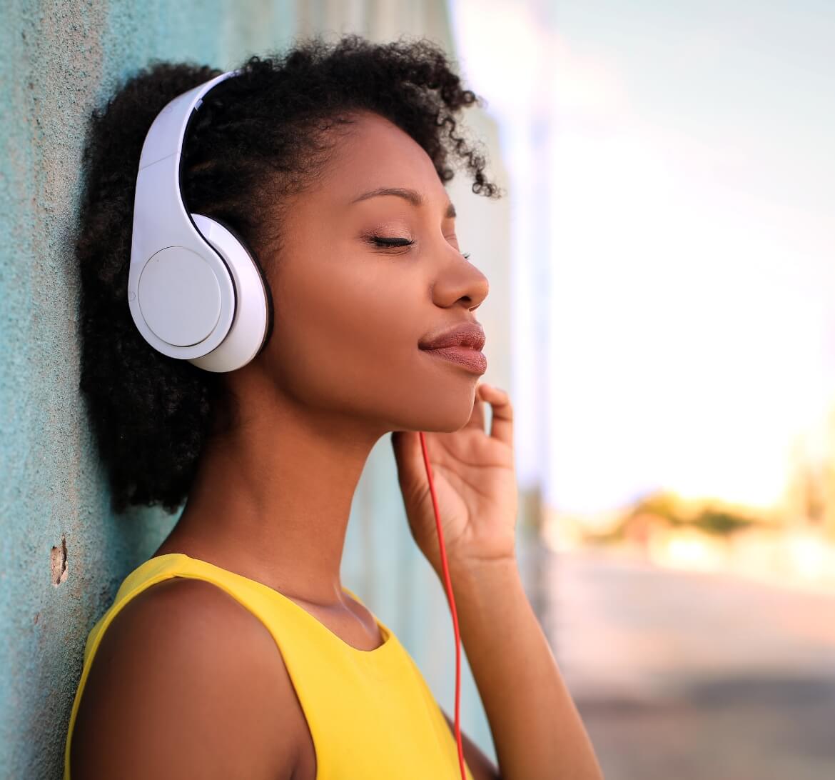 A woman listening to some of her friend's tunes.