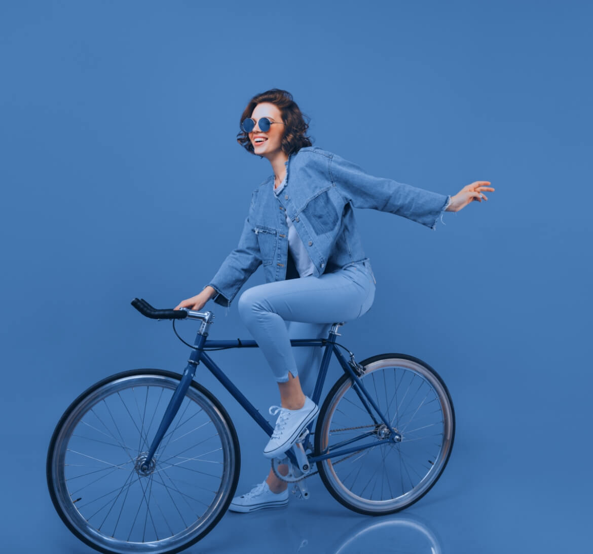 A young woman riding a bike to raise her heart beat.