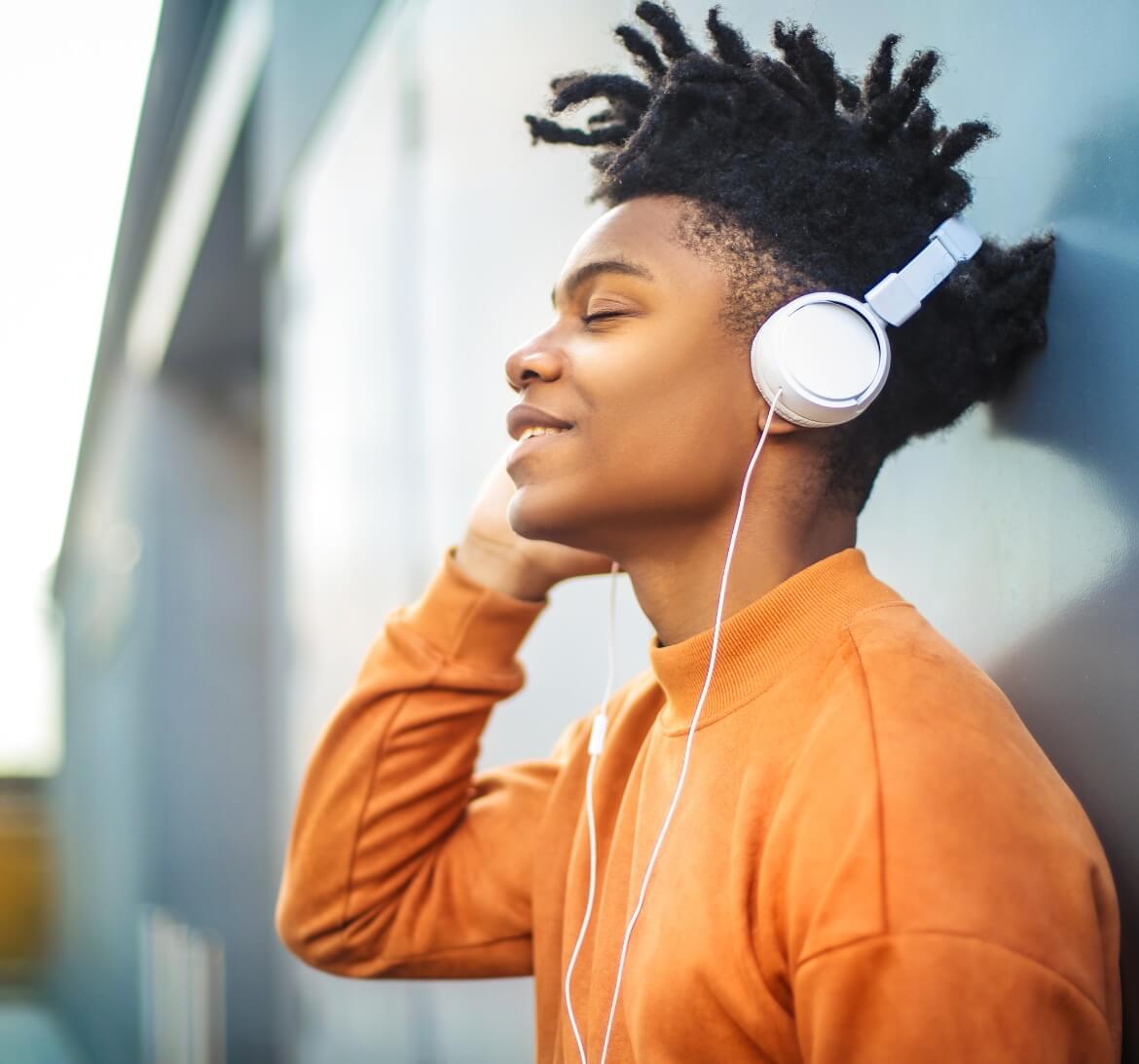 A man listening to some of his friend's tunes.