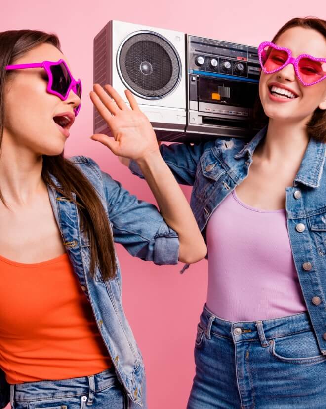 Two young women grooving to some music.