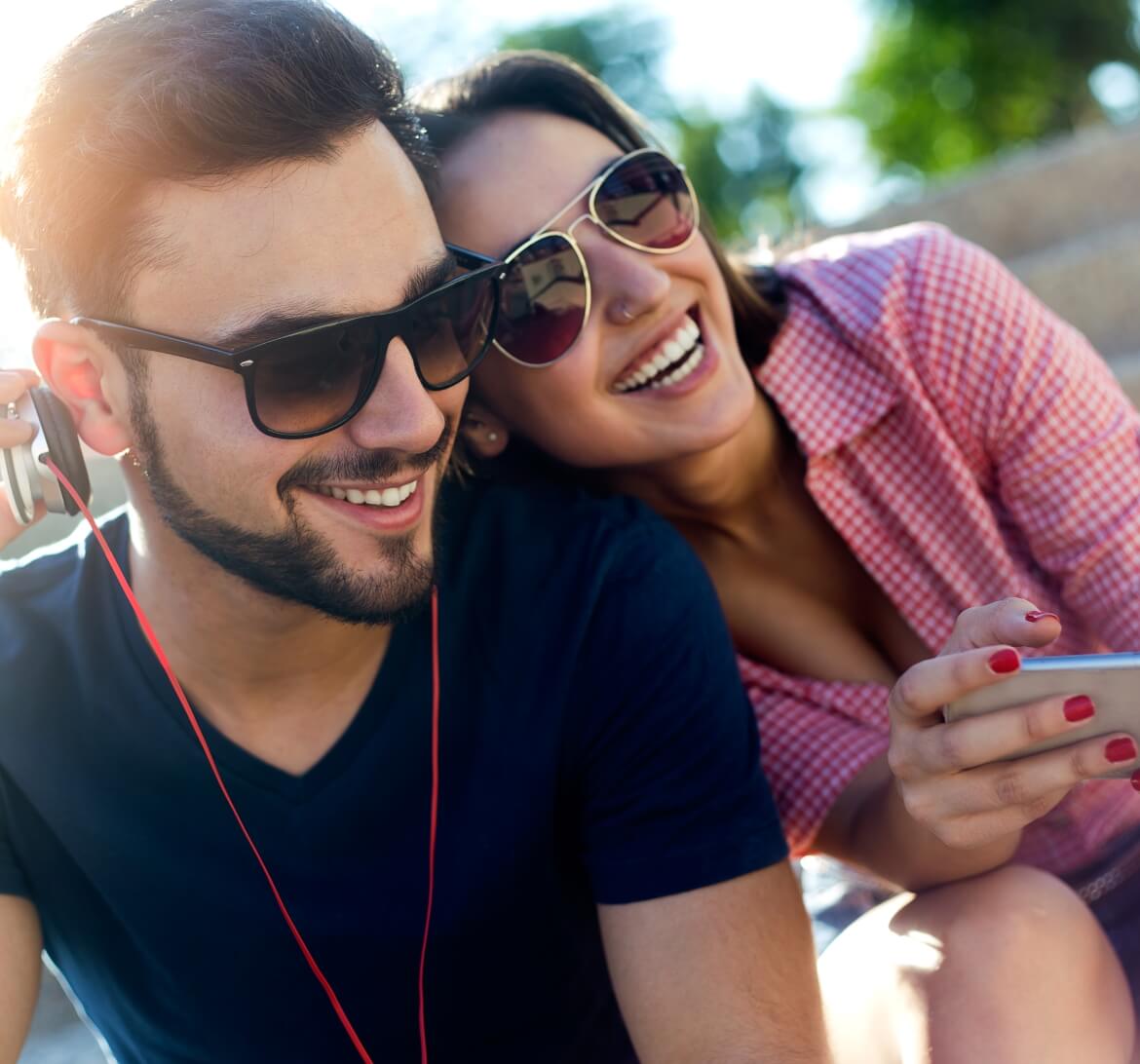 A happy couple listening to music.