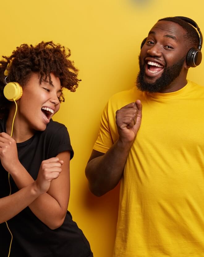 Two people having fun listening to the music they made.